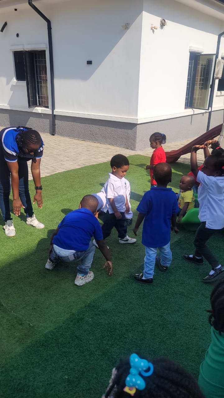 Children playing games together on the green outdoor area