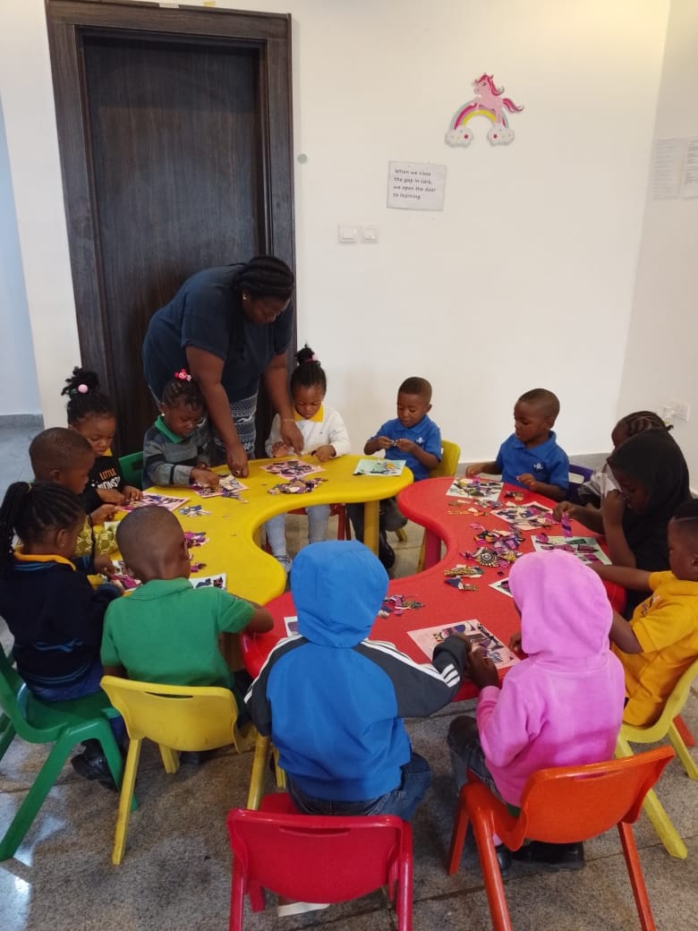 Children building puzzles and crafts at the activity tables